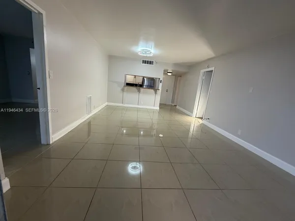 a view of a livingroom with furniture nad an umbrella