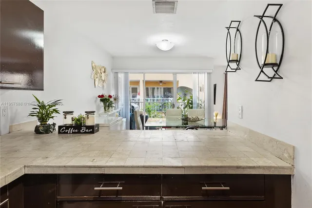 a kitchen with a sink a counter and chairs