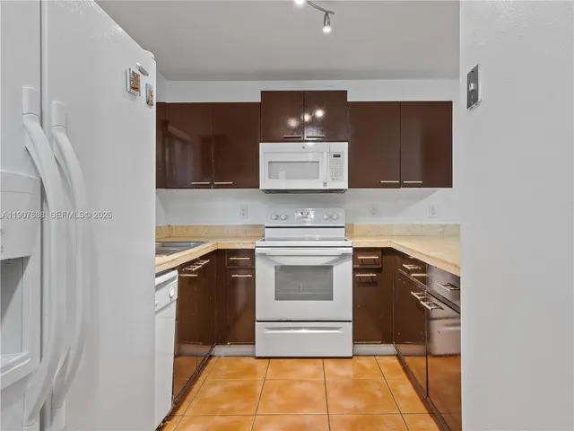 a kitchen with stainless steel appliances granite countertop a stove and a microwave