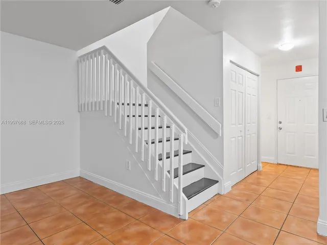 a view of entryway with stairs and wooden floor