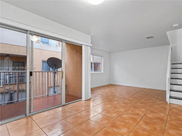 a view of an empty room with windows