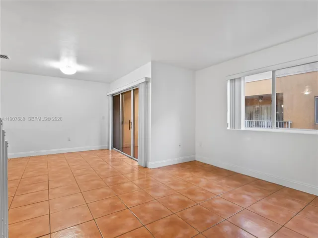 a view of an empty room with windows