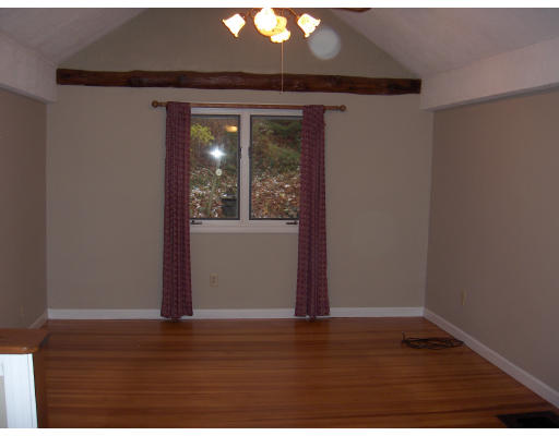 38 Bethany Road Monson, MA 01057 - Photo 3 of 13 an empty room with wooden floor and windows