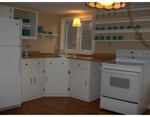 38 Bethany Road Monson, MA 01057 - Photo 4 of 13 a kitchen with granite countertop white cabinets and white appliances