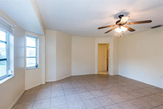 a view of room with window and wooden floor