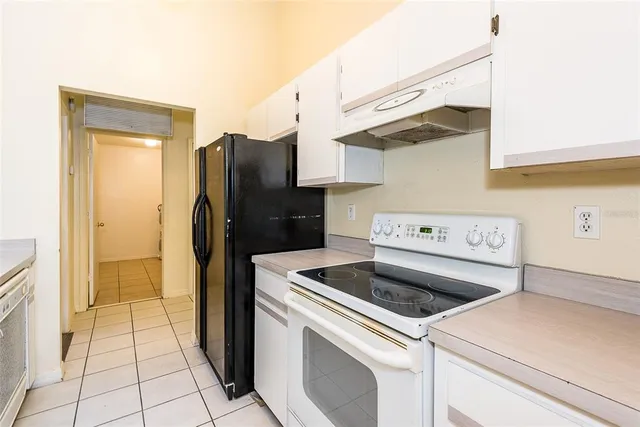 a kitchen with a sink and refrigerator