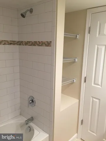 a bathroom with a bathtub and shower