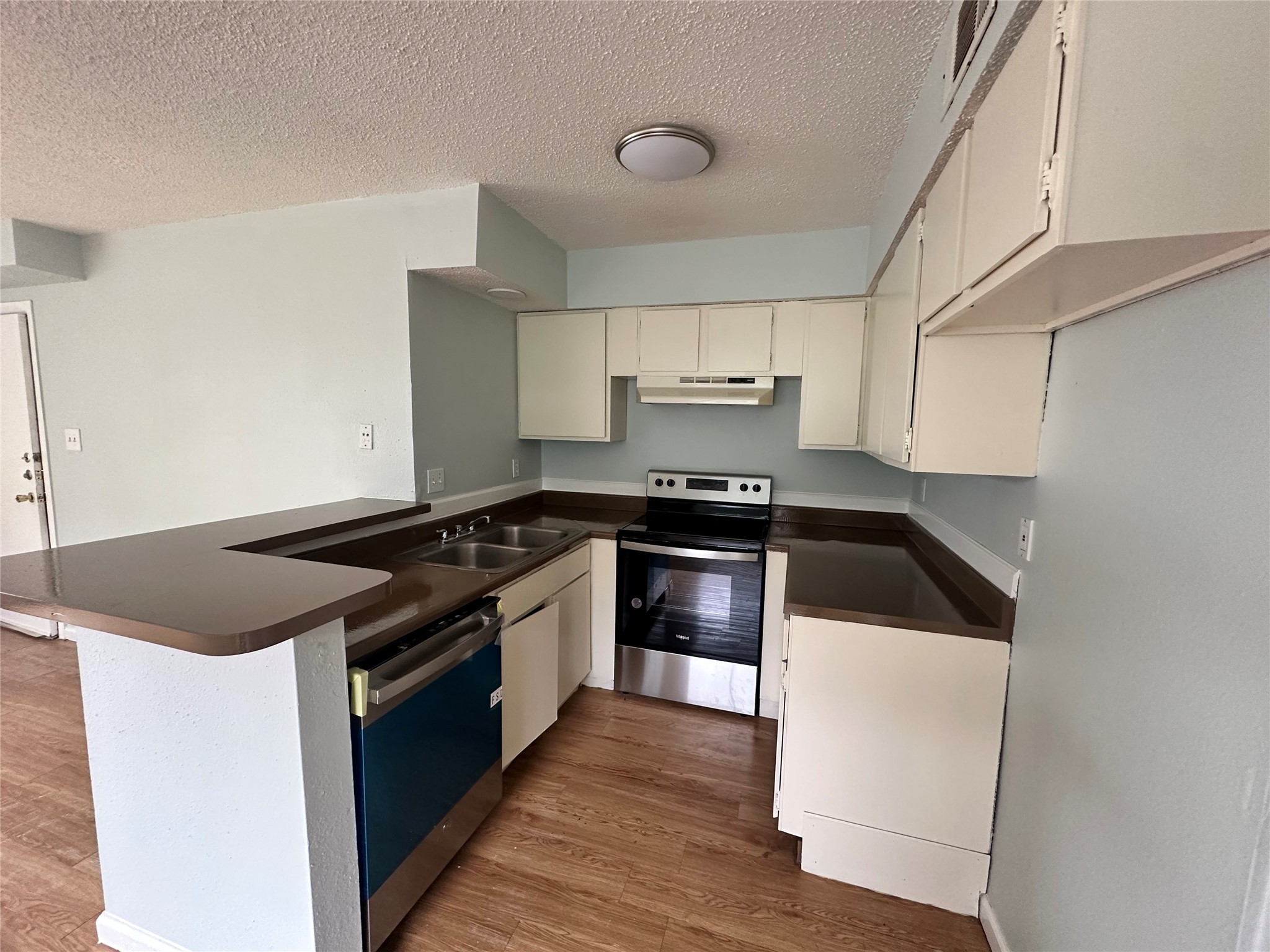 607 Reed Avenue Wharton, TX 77488 - Photo 3 of 13 a kitchen with granite countertop a stove and a sink