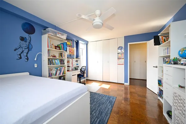 a bedroom with a bed and a book shelf