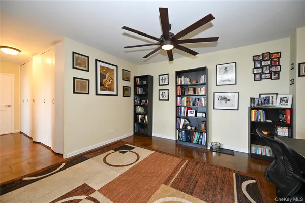 a view of an empty room with workspace and a window