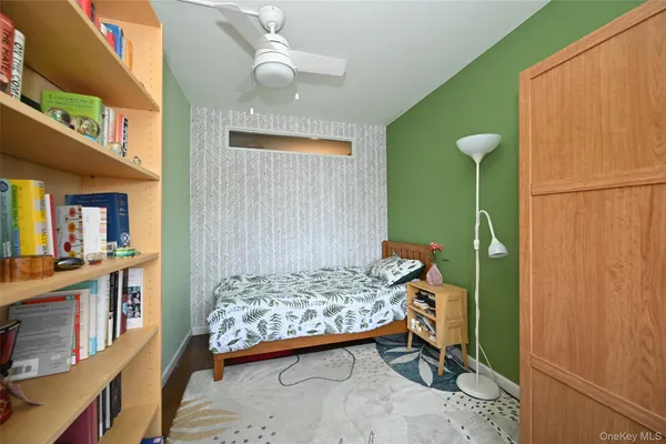 a bedroom with a bed and a baby crib