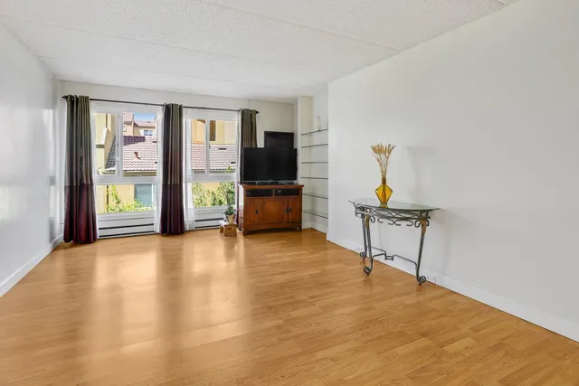 a kitchen with granite countertop cabinets stainless steel appliances a sink and wooden floor