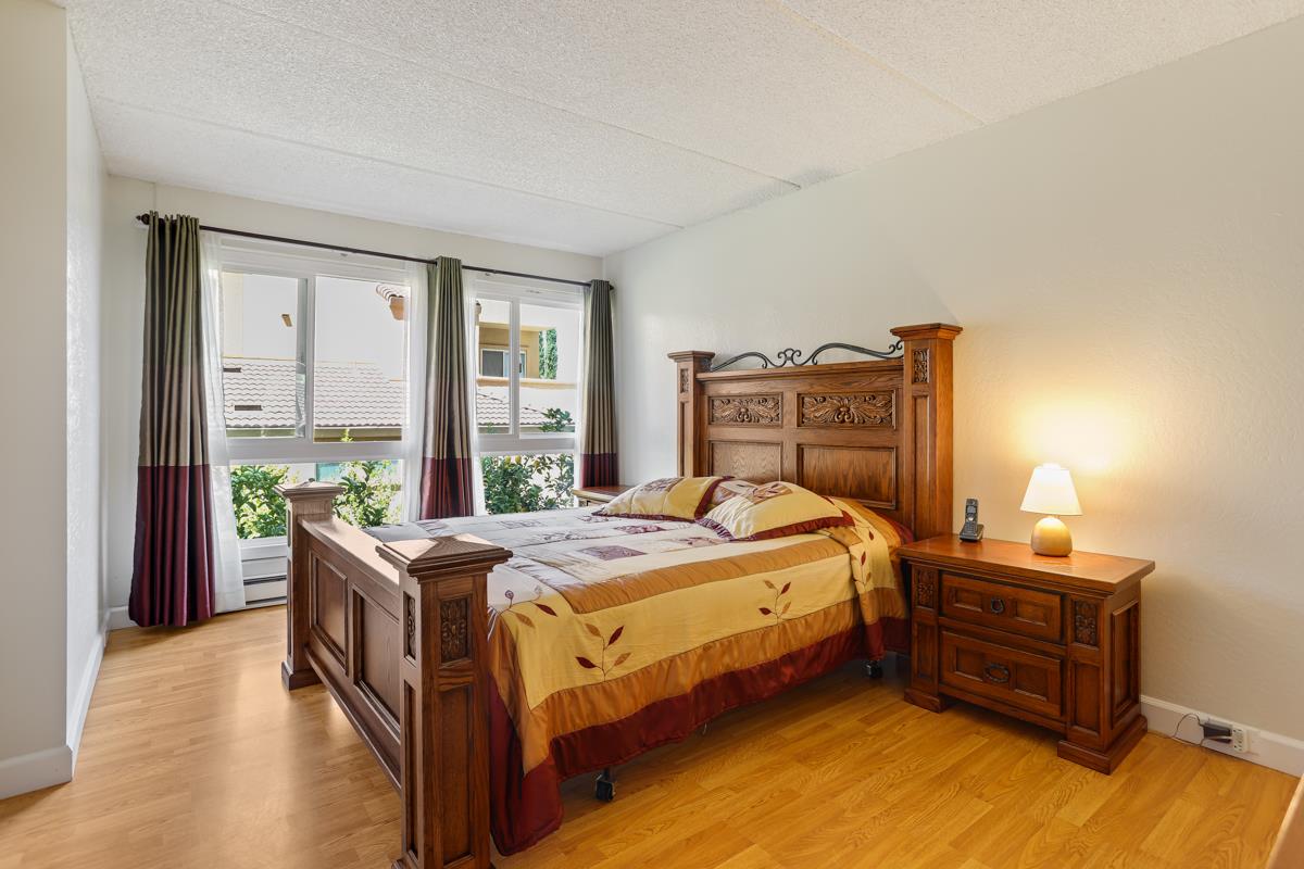 1700 Civic Center Drive, Unit 214 Santa Clara, CA 95050 - Photo 9 of 17 a bedroom with a bed and a large window