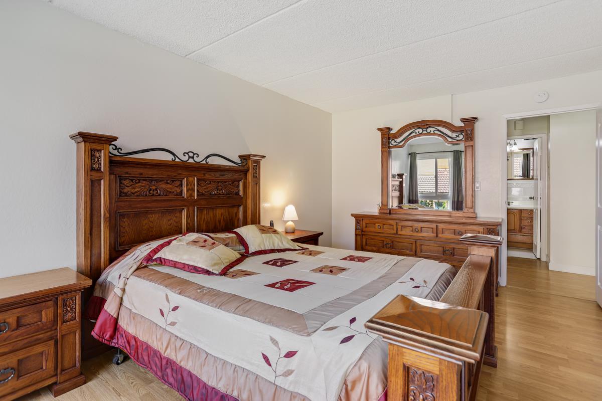 1700 Civic Center Drive, Unit 214 Santa Clara, CA 95050 - Photo 10 of 17 a bed room with a bed and a chair