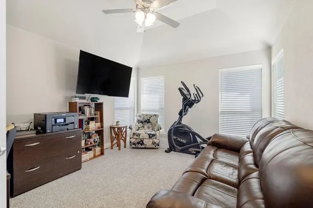 a view of a livingroom with workspace and a window