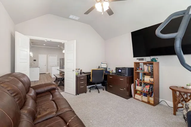 a livingroom with workspace and a couch