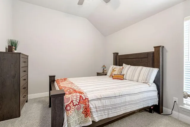 a bed sitting in a bedroom next to a cabinet