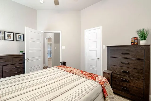 a bedroom with a bed and a dresser