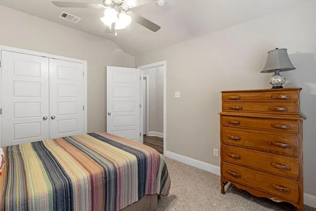 a bedroom with a bed and a closet