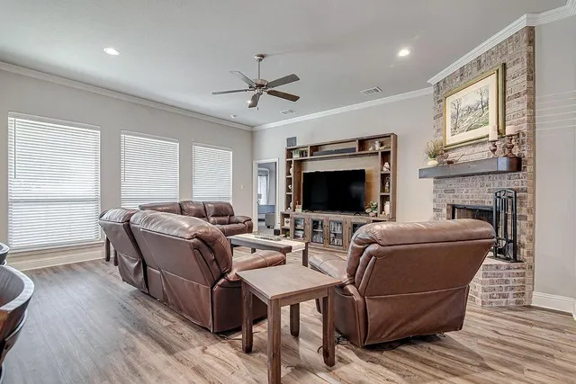 a living room with furniture a flat screen tv and a fireplace