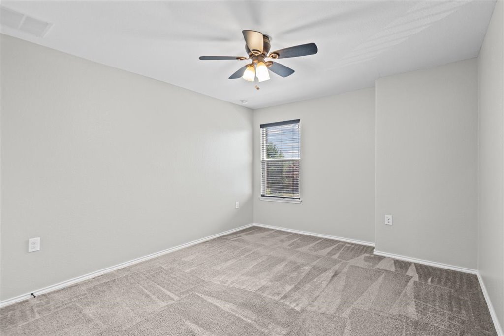 8804 Capitol View Drive Austin, TX 78747 - Photo 29 of 32 an empty room with a window and a fan