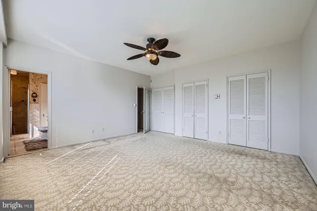 a view of empty room with ceiling fan