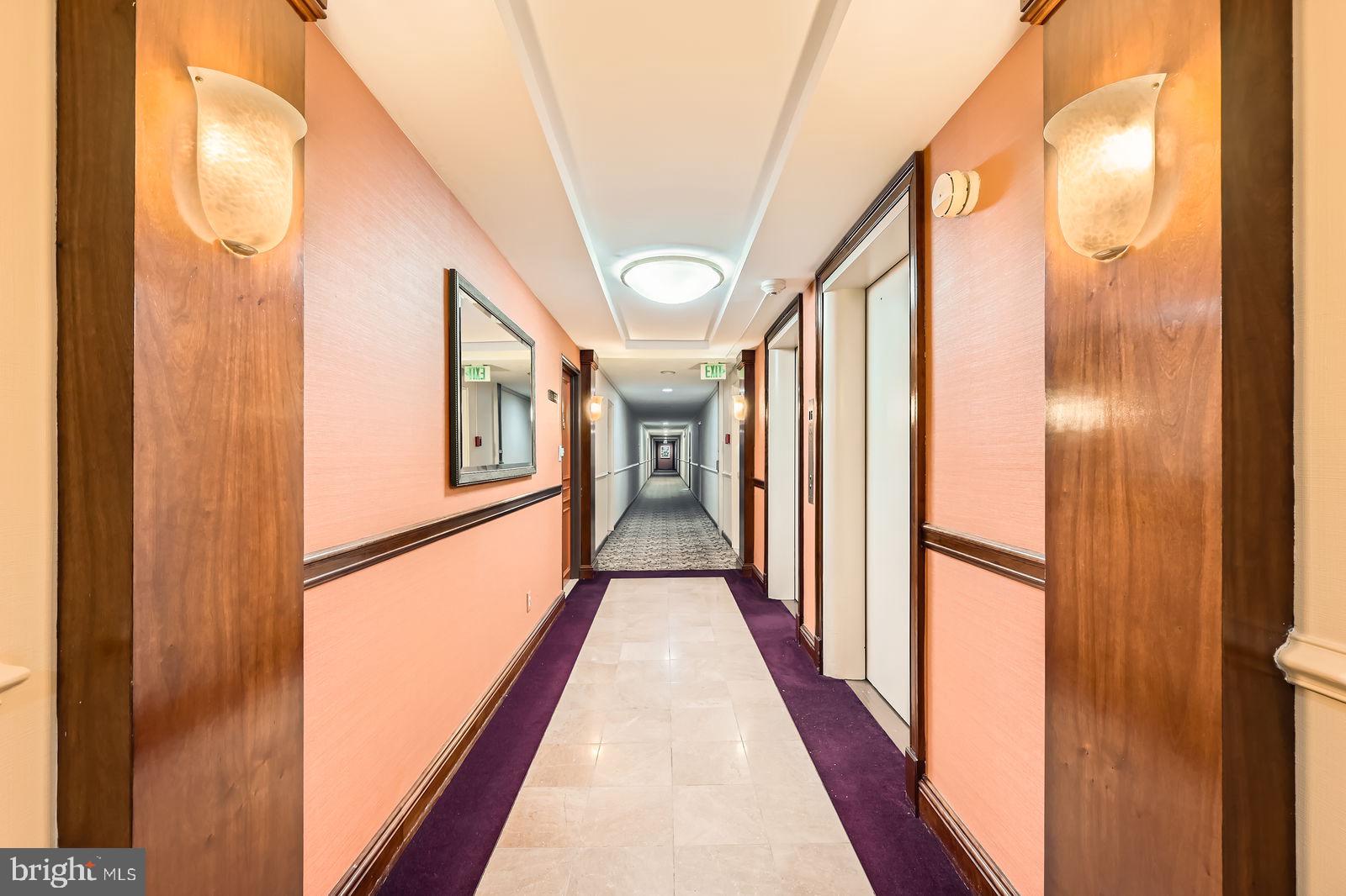 11 Slade Avenue, Unit 509 Baltimore, MD 21208 - Photo 27 of 30 a view of a hallway with wooden floor and staircase