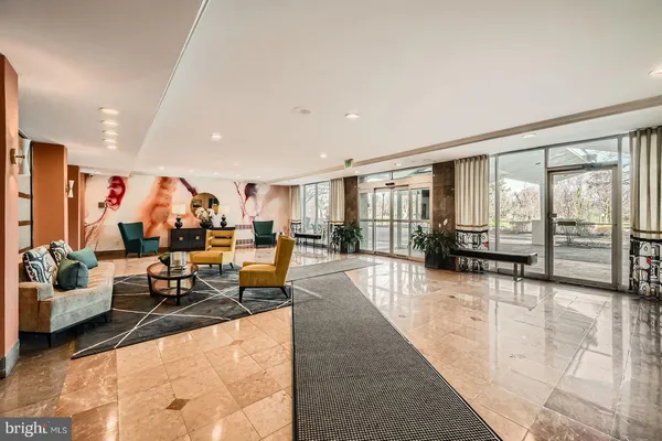 a lobby with furniture and floor to ceiling window