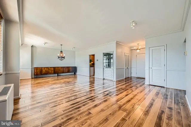 a view of empty room with wooden floor