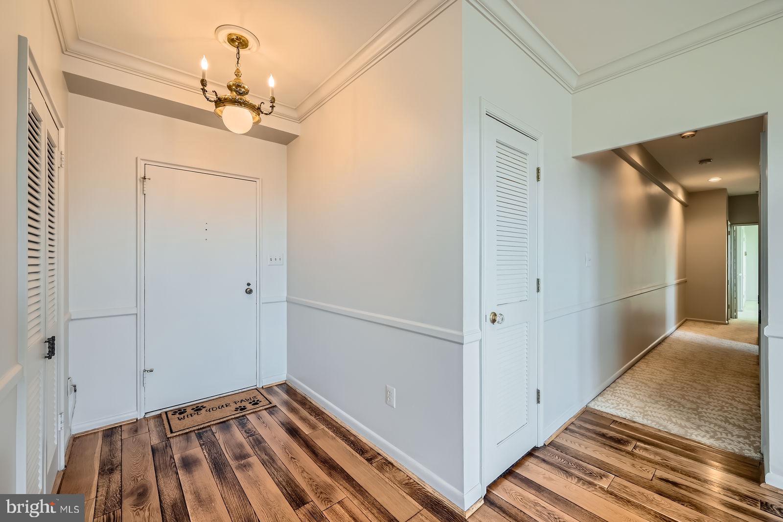 11 Slade Avenue, Unit 509 Baltimore, MD 21208 - Photo 5 of 30 a view of a hallway with wooden floor and staircase