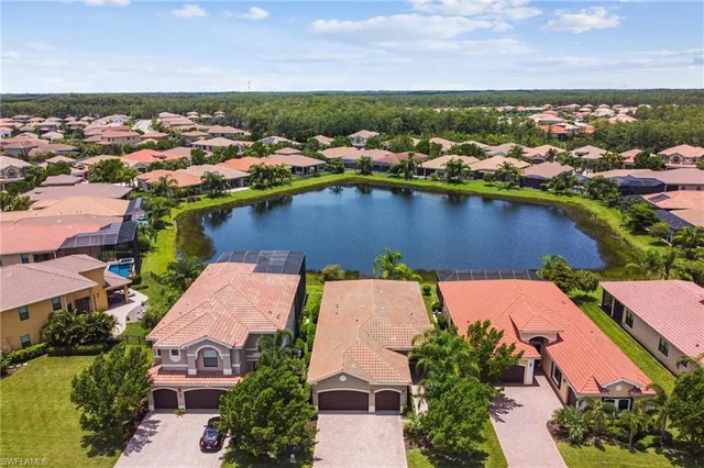 an aerial view of a house with a lake view