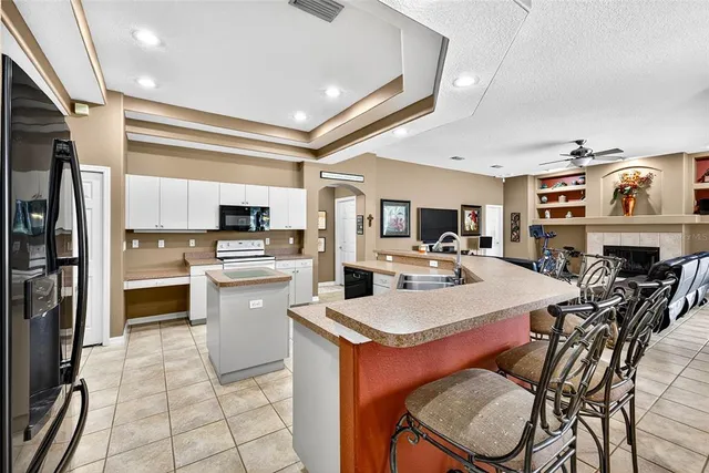a kitchen with stainless steel appliances a refrigerator sink and cabinets