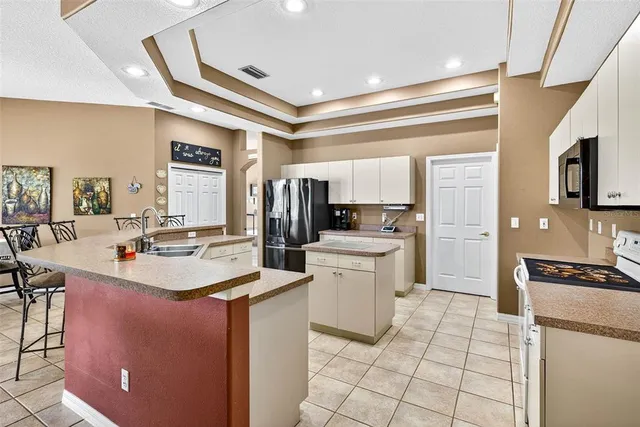 a view of a dining room with furniture wooden floor and a chandelier