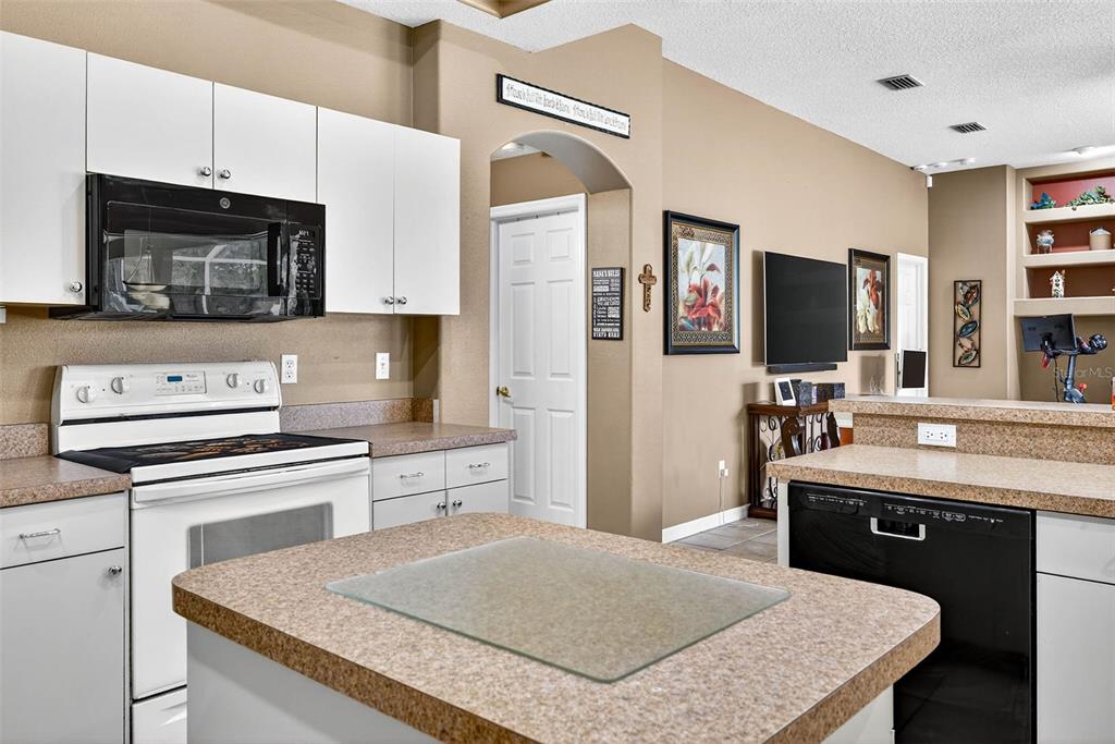 8518 West Knights Griffin Road Plant City, FL 33565 - Photo 17 of 74 a kitchen with stainless steel appliances granite countertop a stove refrigerator sink and microwave