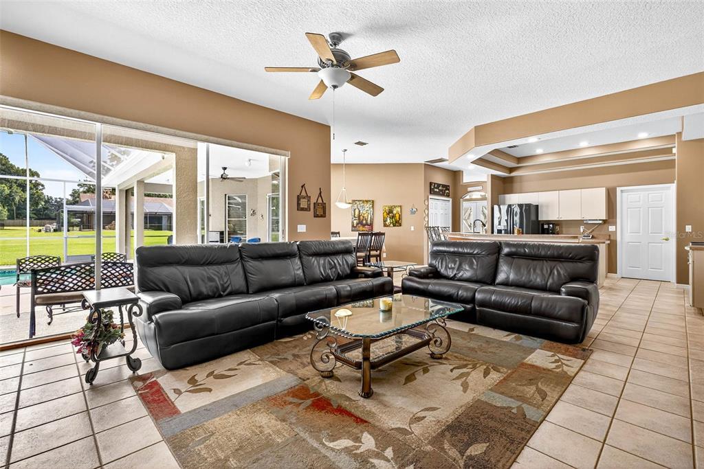8518 West Knights Griffin Road Plant City, FL 33565 - Photo 25 of 74 a living room with furniture and a large window