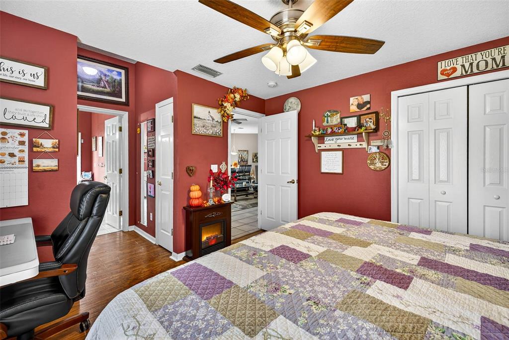 8518 West Knights Griffin Road Plant City, FL 33565 - Photo 33 of 74 a bedroom with a bed dresser and a chandelier