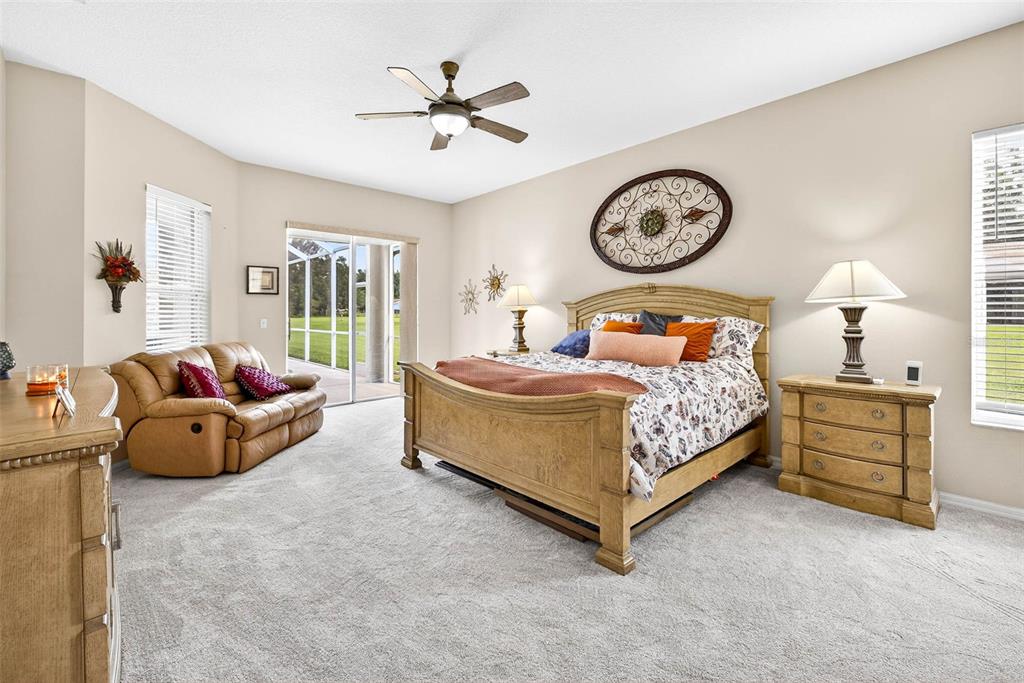 8518 West Knights Griffin Road Plant City, FL 33565 - Photo 35 of 74 a bedroom with bed and a chandelier