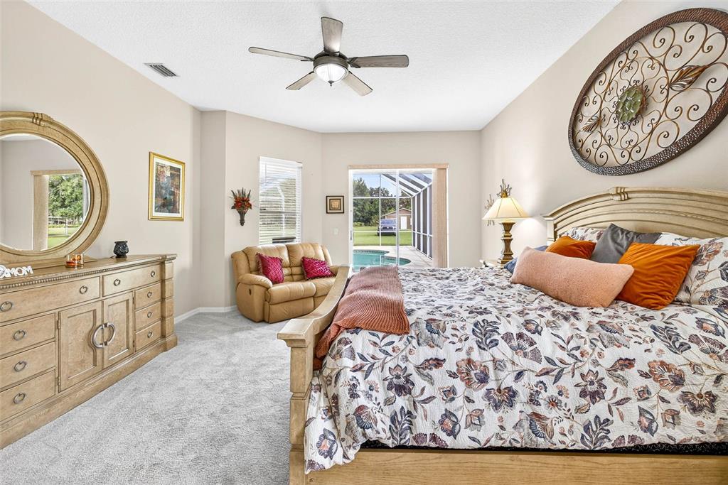 8518 West Knights Griffin Road Plant City, FL 33565 - Photo 36 of 74 a bedroom with a bed and a chandelier