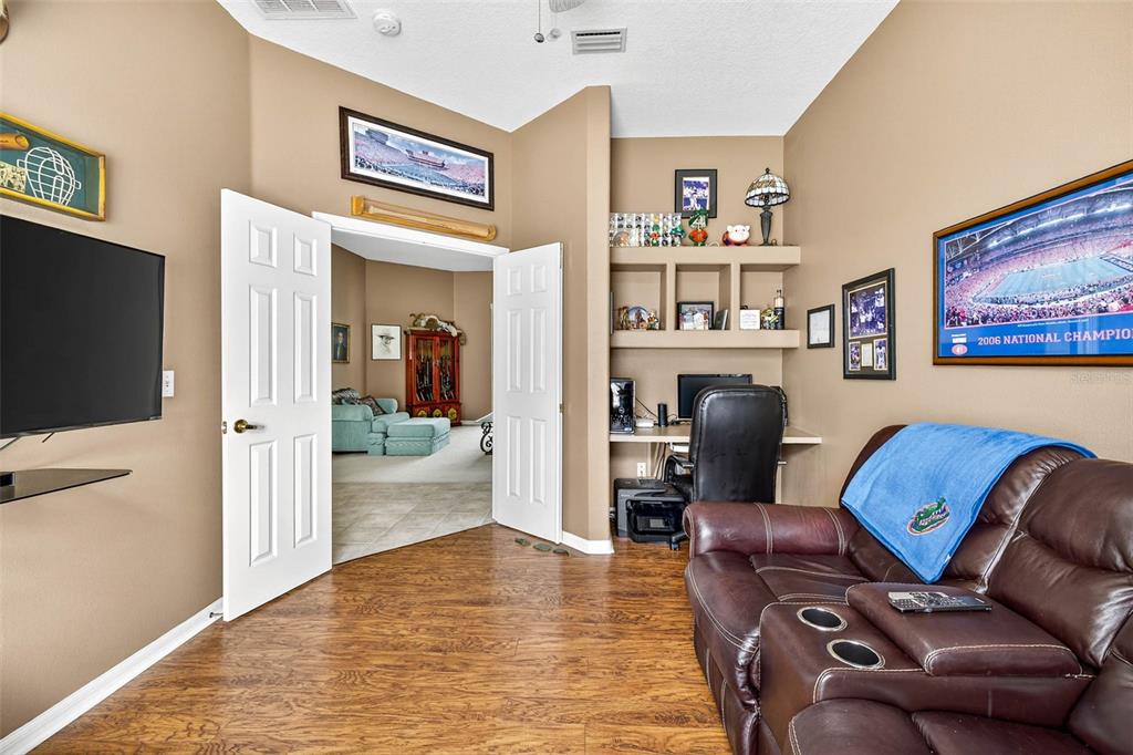 8518 West Knights Griffin Road Plant City, FL 33565 - Photo 44 of 74 a living room with furniture and a flat screen tv