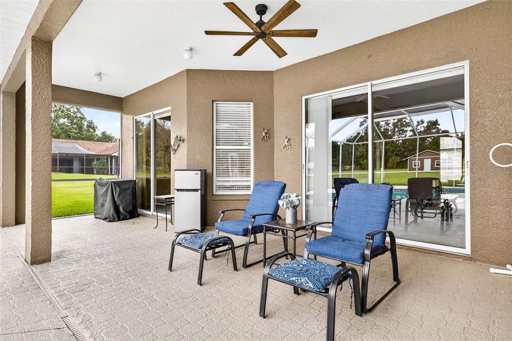 8518 West Knights Griffin Road Plant City, FL 33565 - Photo 48 of 74 a living room with furniture and a floor to ceiling window