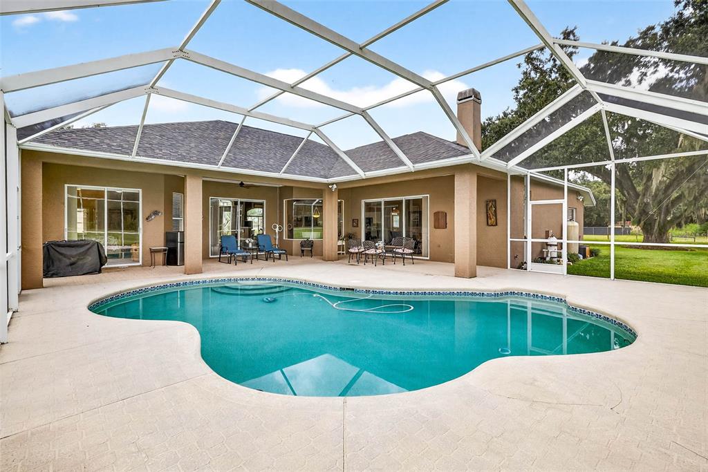 8518 West Knights Griffin Road Plant City, FL 33565 - Photo 53 of 74 a view of a house with swimming pool