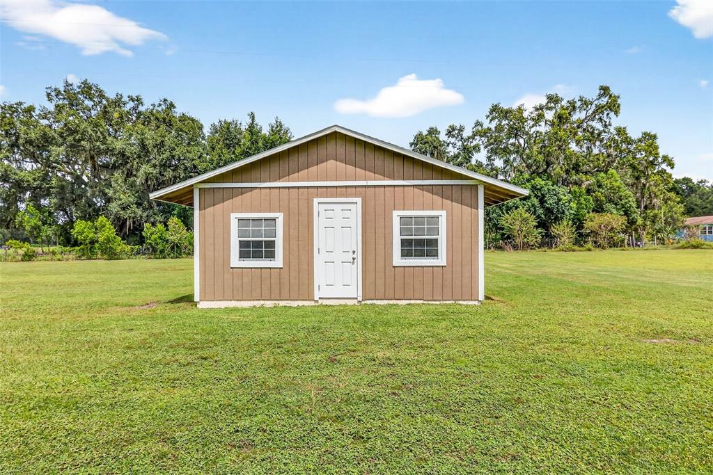 8518 West Knights Griffin Road Plant City, FL 33565 - Photo 56 of 74 a view of a house with yard and green space