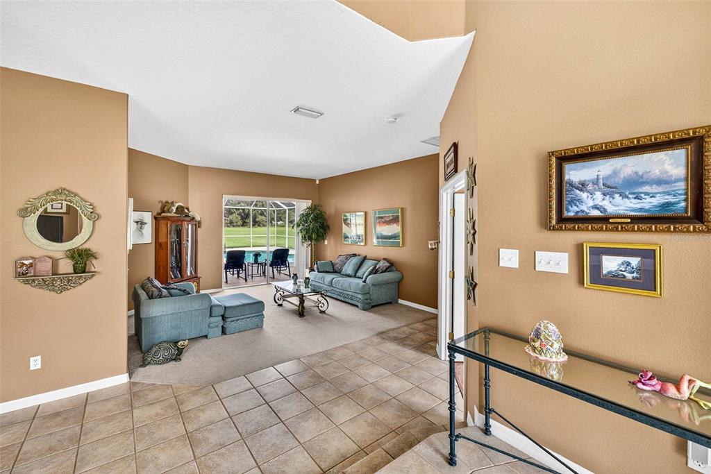 8518 West Knights Griffin Road Plant City, FL 33565 - Photo 6 of 74 a living room with furniture and a flat screen tv