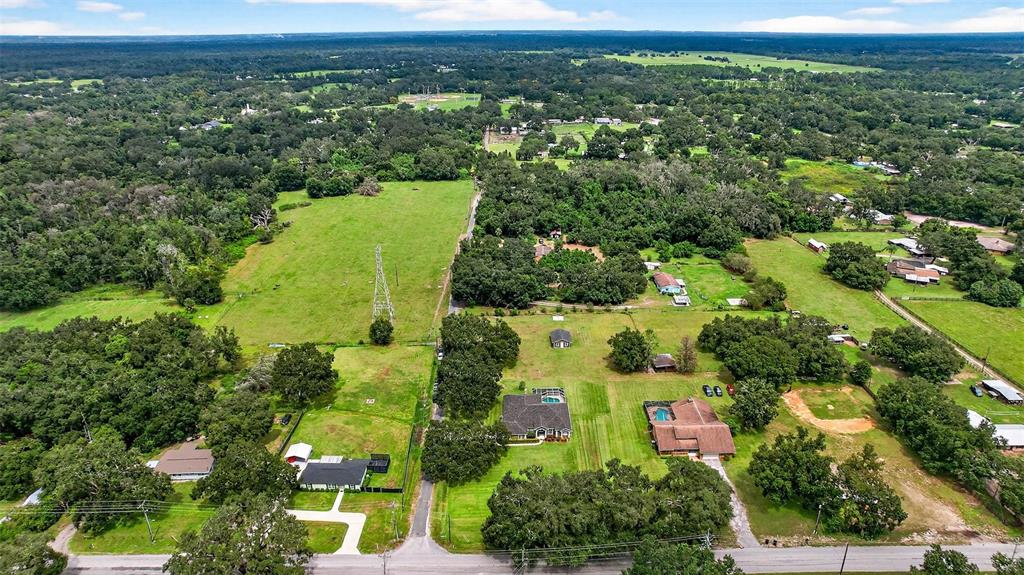 8518 West Knights Griffin Road Plant City, FL 33565 - Photo 66 of 74 an aerial view of a residential houses with outdoor space and trees