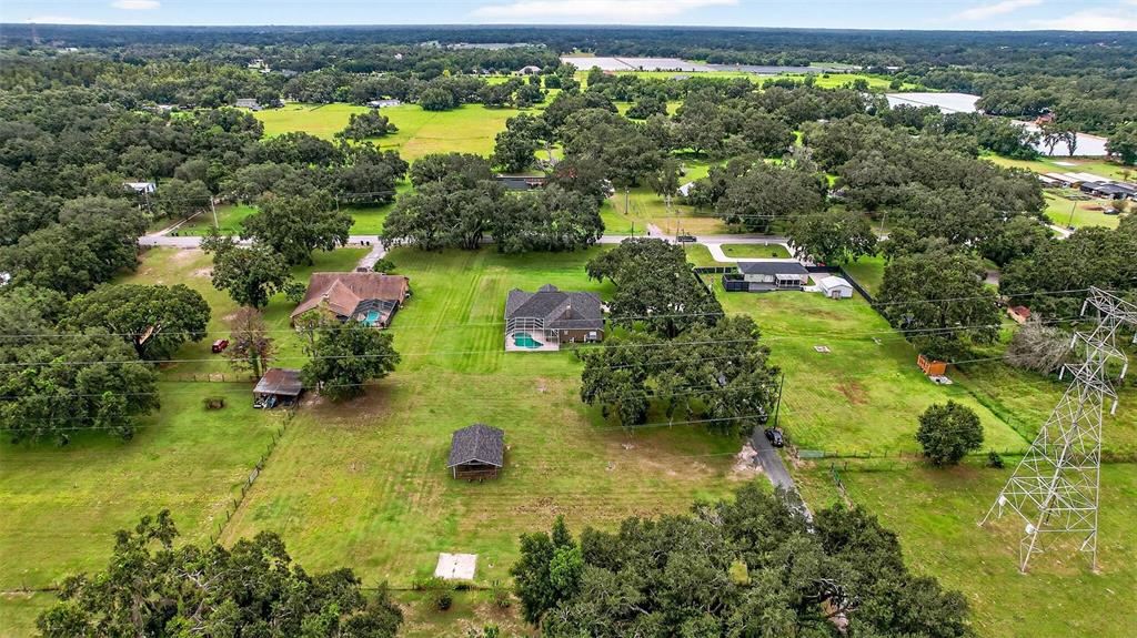8518 West Knights Griffin Road Plant City, FL 33565 - Photo 68 of 74 an aerial view of residential houses with outdoor space and trees all around