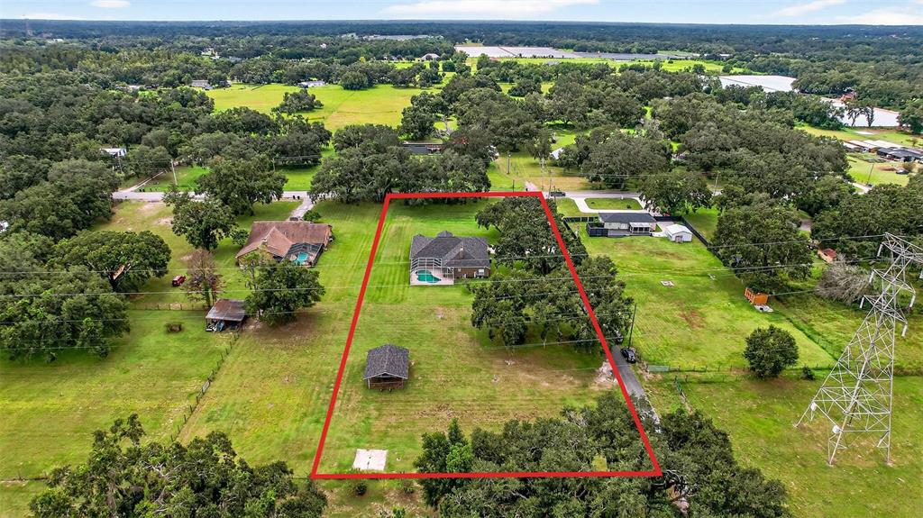 8518 West Knights Griffin Road Plant City, FL 33565 - Photo 69 of 74 an aerial view of residential houses with outdoor space and trees all around