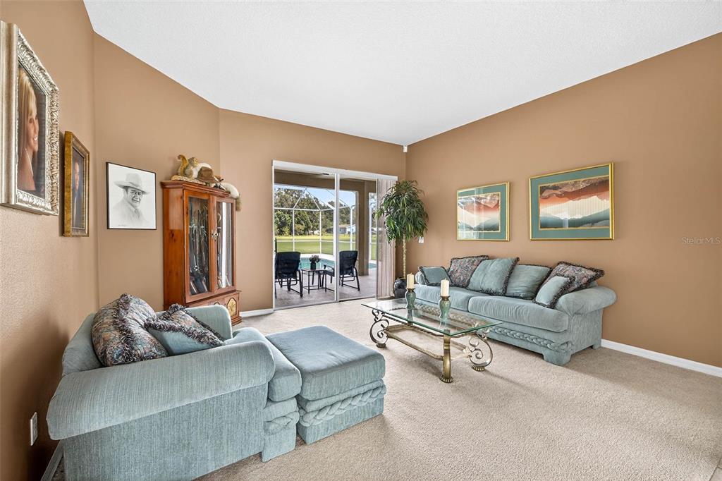8518 West Knights Griffin Road Plant City, FL 33565 - Photo 8 of 74 a living room with furniture and a large window