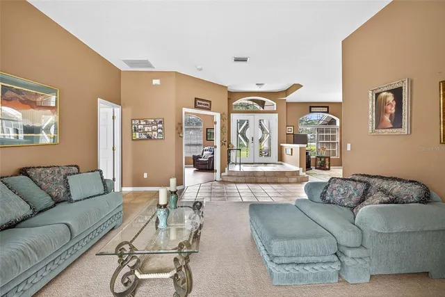 a large kitchen with a table chairs refrigerator and cabinets
