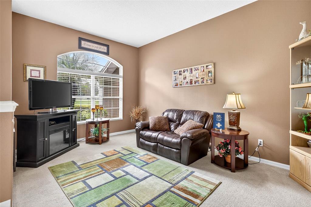 8518 West Knights Griffin Road Plant City, FL 33565 - Photo 10 of 74 a living room with furniture and a flat screen tv