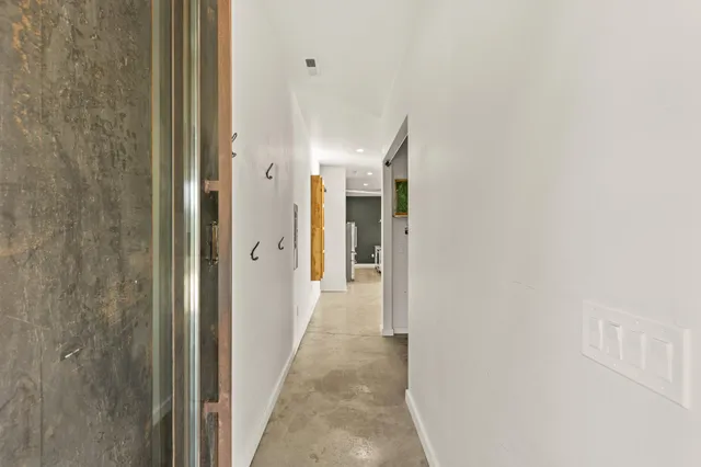 a view of a kitchen with kitchen island a sink stainless steel appliances and a counter top space